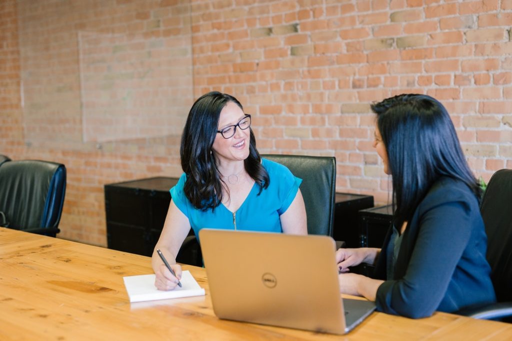 Two women talking in a training session.